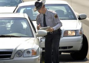 OfficerWritingTicket Highway Patrol Officer writing a traffic ticket to a motorist