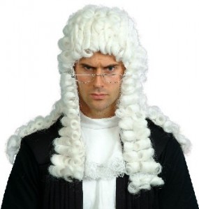 Silly image of a guy with a white, curly haired wig on that looks like it is from the 1800's.