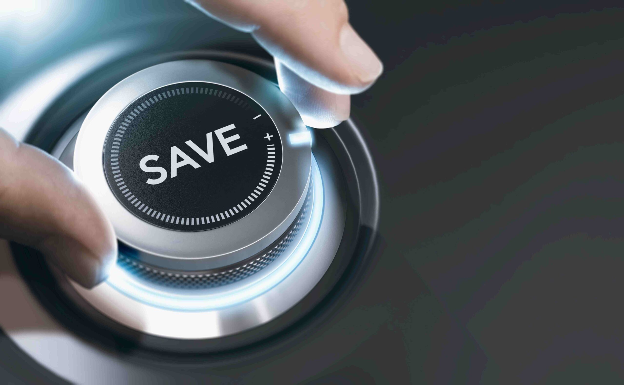 A hand turns the dial toward savings to represent the money anyone can save with a New York Defensive Driving Course Auto Insurance Discount.
