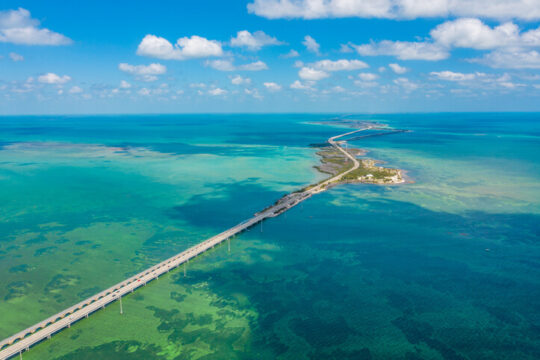 Drone point of view shot of a bridge and islands in the sea under a blue sunny sky, Key West, Florida, USA