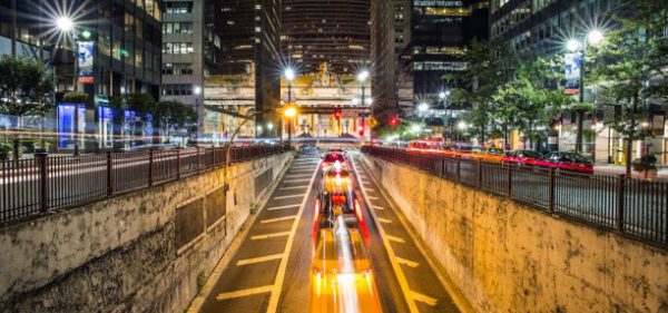 Long exposure image of a city street with blurred headlights from the cars.