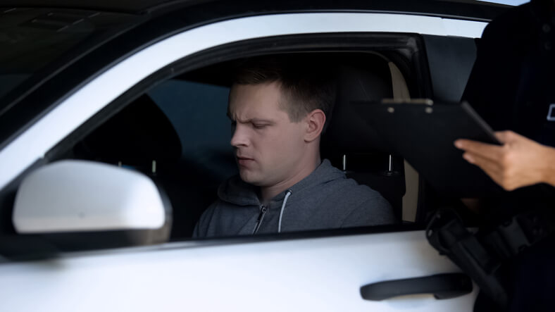 A person receiving a reckless driving ticket in California.