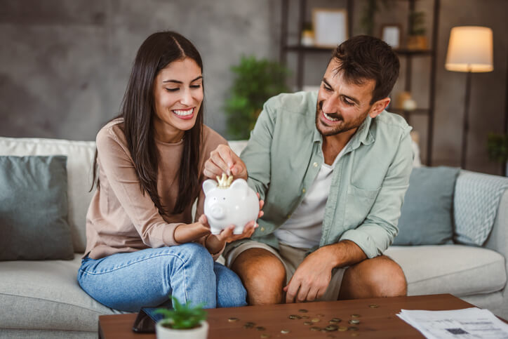 A happy couple counts their savings as the celebrate the completion of their defensive driving courses, reducing insurance costs for the whole family.